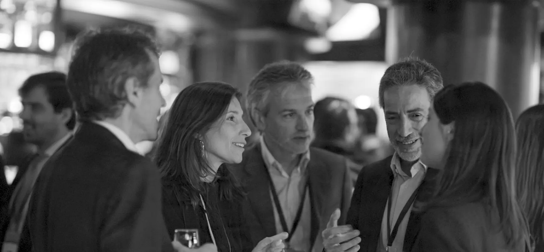 Members talking at a bar during a gathering